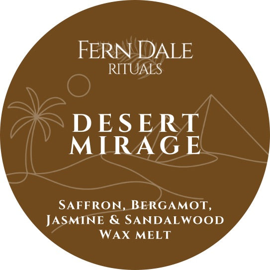 Desert Mirage round brown wax melt label with cream lettering and line drawings of a palm tree, sun, dunes and pyramid.