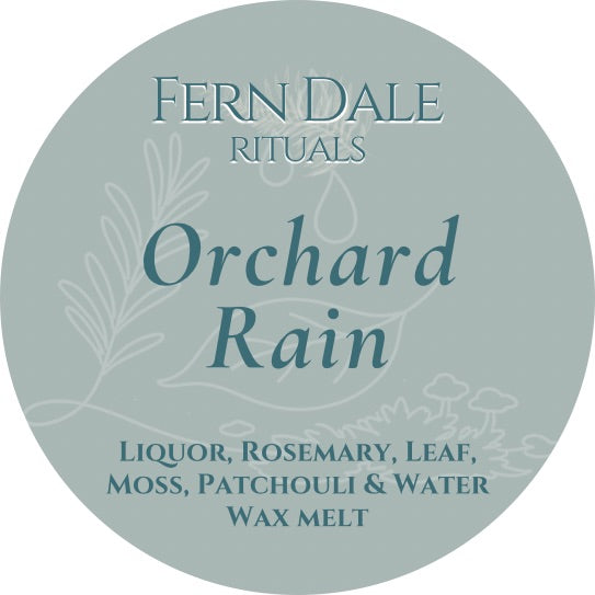 Orchard Rain circular pale green wax melt label with teal lettering and delicate leaf and mushroom outlines.
