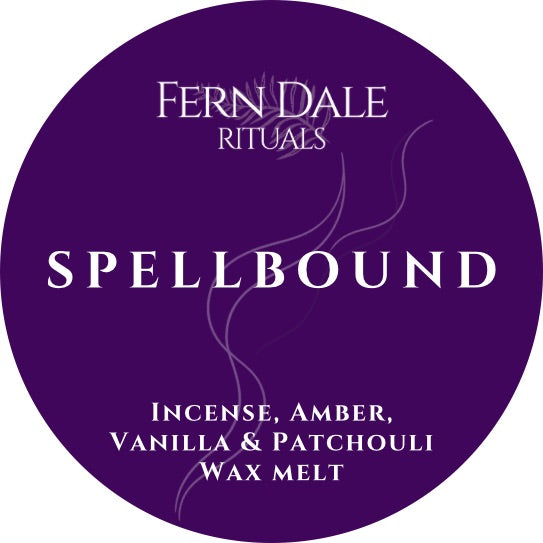 Spellbound round purple wax melt label with white lettering and fine wispy lines.