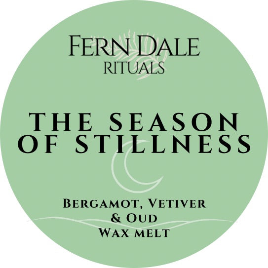 The Season of Stillness round pale green wax melt label with black lettering and a crescent moon design.